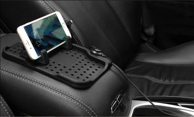 Black silicone car charging bracket with magnetic holder and three charging ports on a dashboard