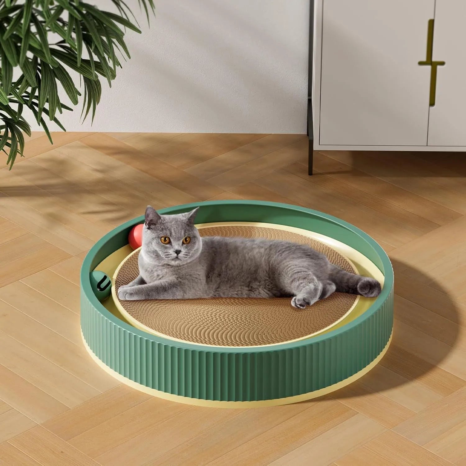 Large circular cat scratching board with integrated ball toys measuring 45cm diameter