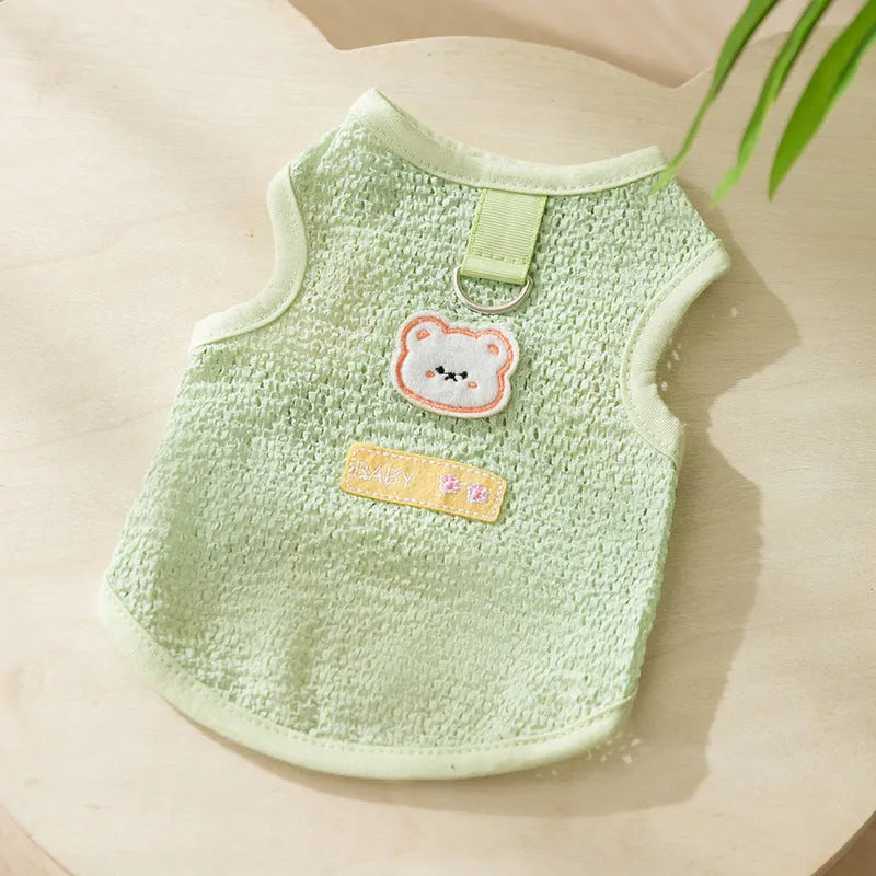 Green knitted cat clothing with a bear patch and breathable hollowed-out design on a cat model.
