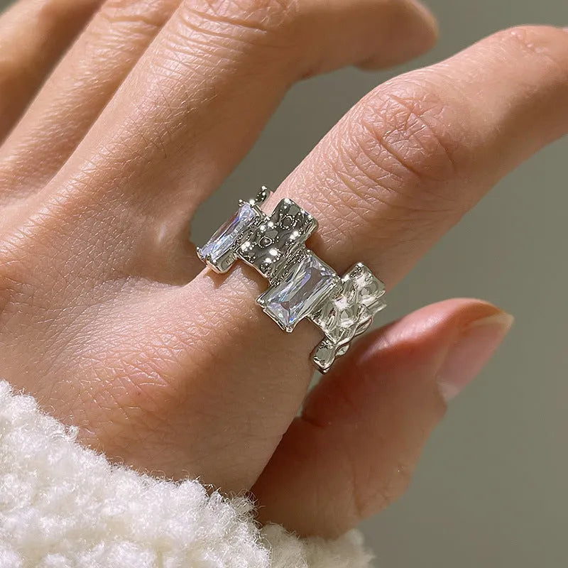 Silver geometric cross ring with open zircon gemstone setting and three-dimensional decoration