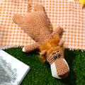 Green plush dog chew toy shaped like an animal with a textured corn kernel surface.
