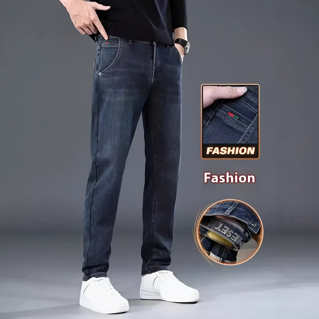 Blue grey slim straight casual trousers with a mid waist and zip fly on a neutral background.