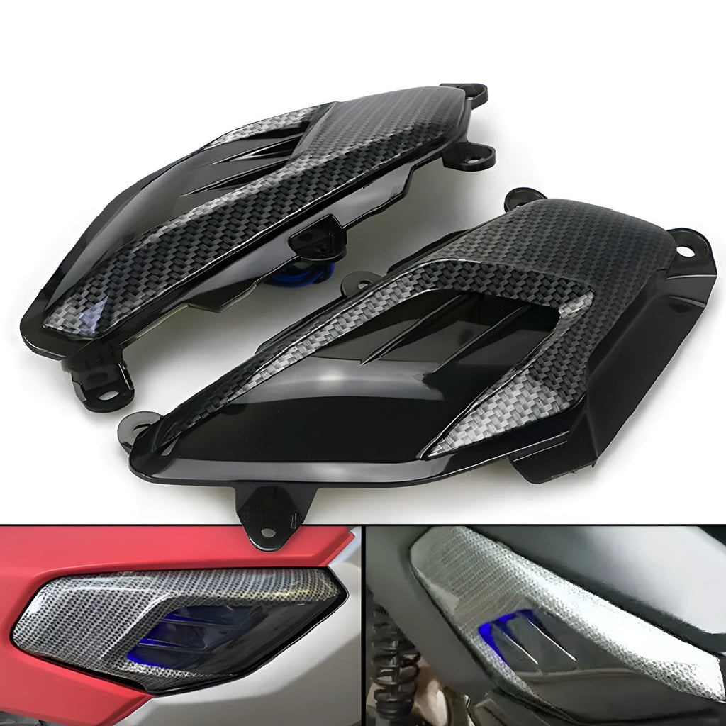 Pair of Yamaha NMAX LED side lamps with carbon fibre design on a blue background.