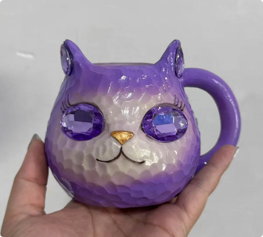 Purple, green, blue, and pink resin cat cup crystal earth craft ornament on display.