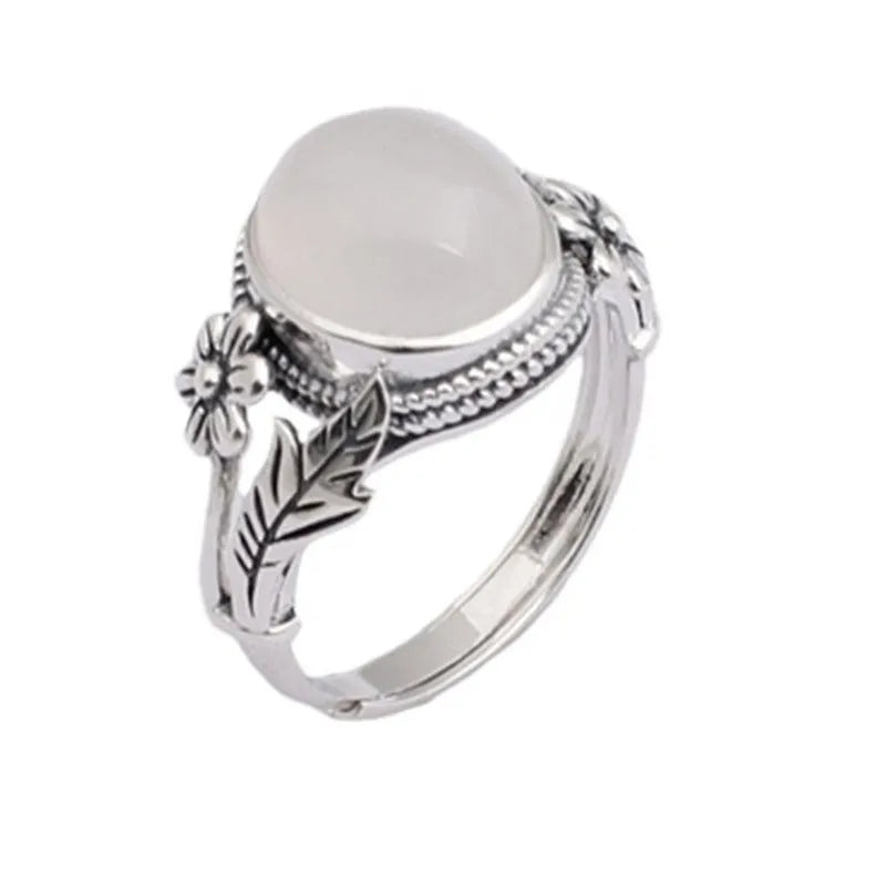 Adjustable copper vintage ring with imitation white chalcedony stone on a U-shaped band.