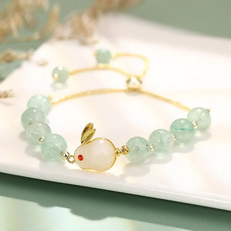 Rabbit charm bracelet with green aventurine stone on copper and gold chain.