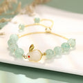Rabbit charm bracelet with green aventurine stone on copper and gold chain.