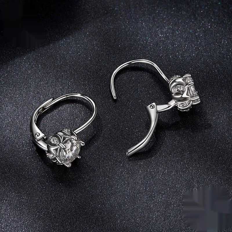 Close-up of a sterling silver flower bud ear clip with a white gold plated finish and a central 0.5 carat moissanite stone.
