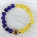 Handmade women's yellow and purple amethyst crystal bracelet showing manual craftsmanship details