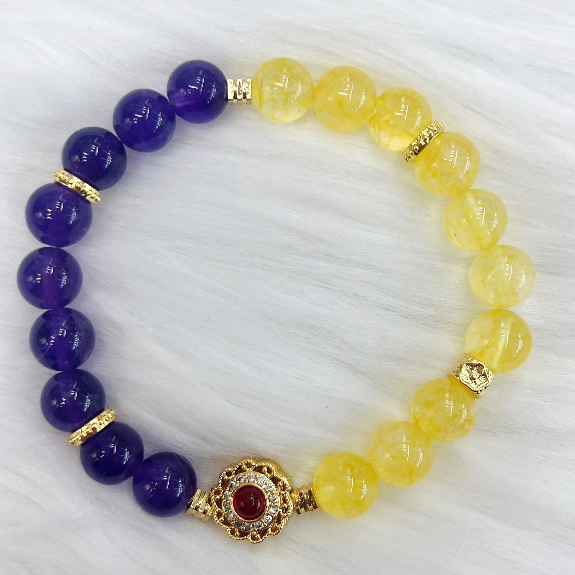 Handmade women's yellow and purple amethyst crystal bracelet showing manual craftsmanship details