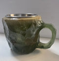 Purple and blue resin coffee mug with crystal texture and handle on wooden table