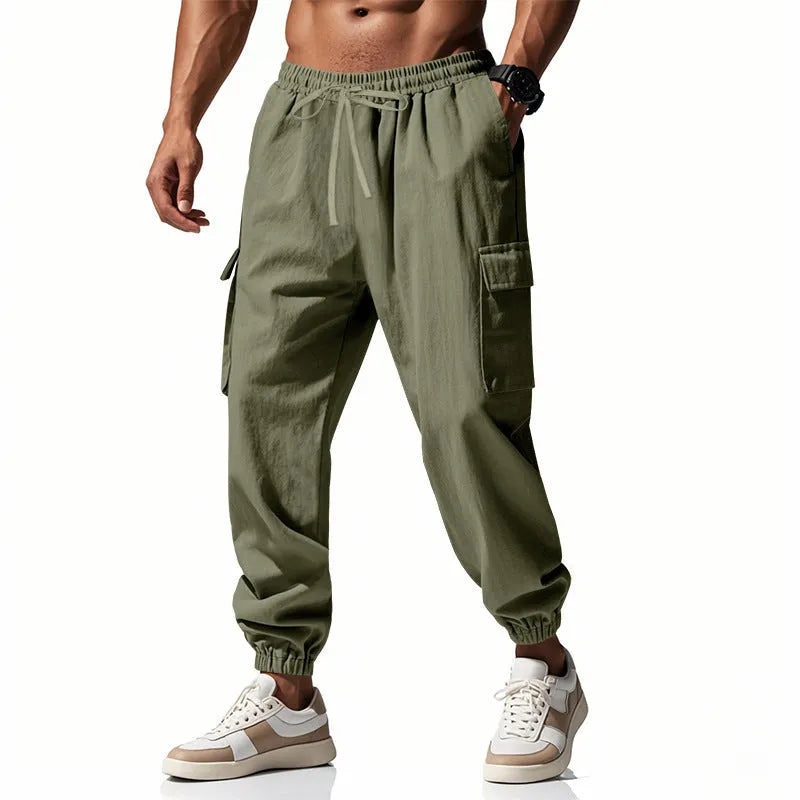 Men's loose-fit linen casual trousers with ankle-tied cuffs and multiple pockets in a solid colour.