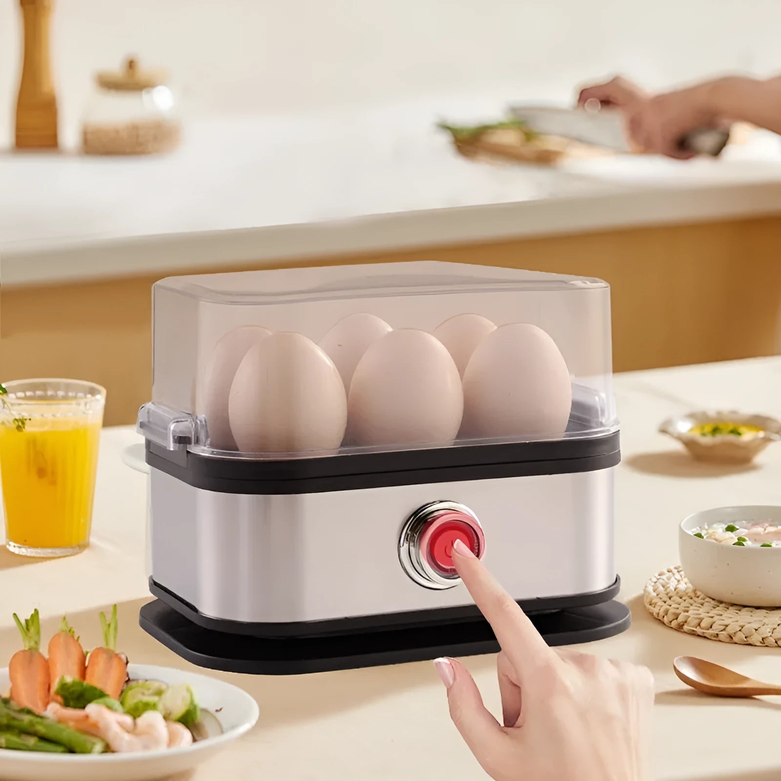 Black portable stainless steel egg boiler with a carrying belt.