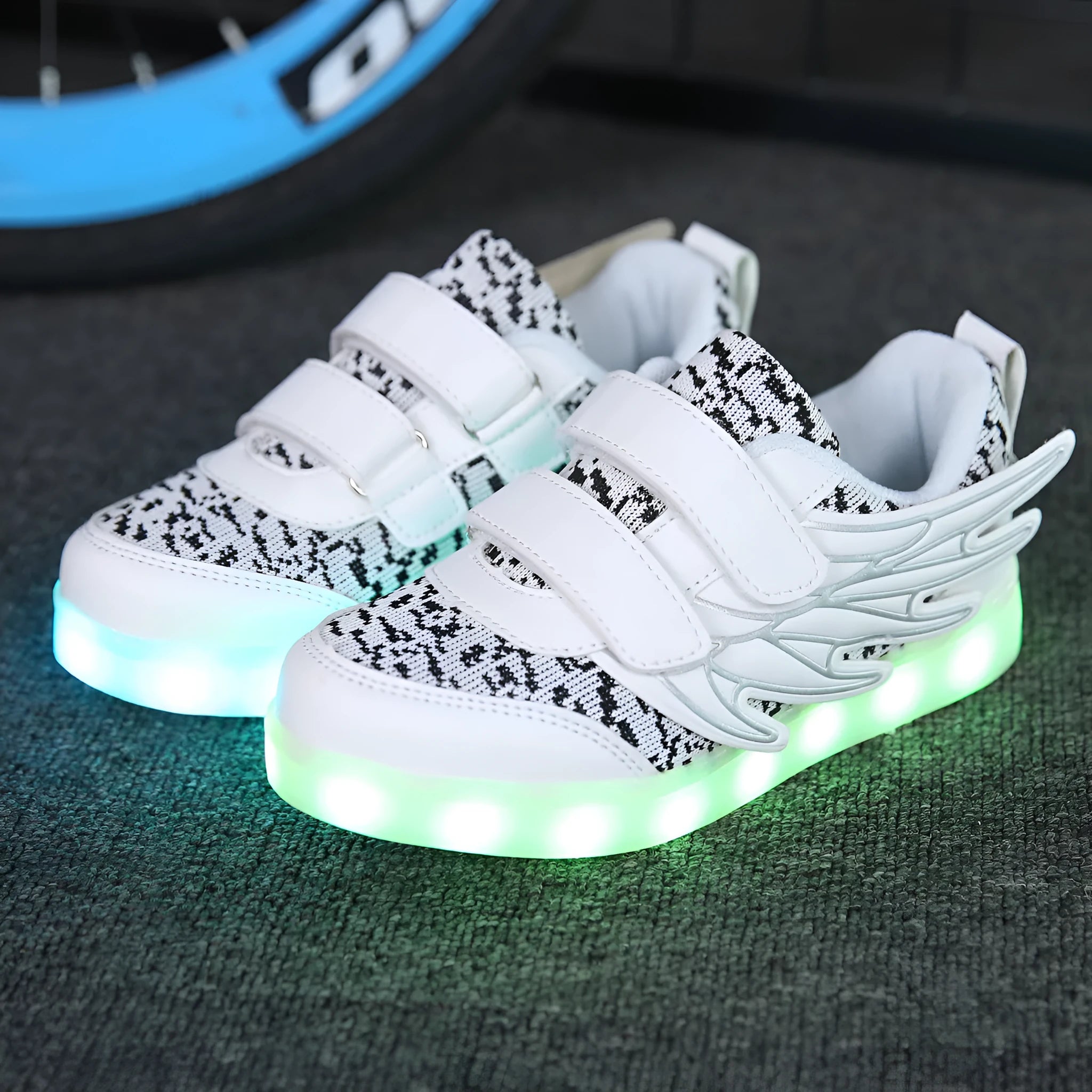 Plum red children's sneakers with illuminated LED soles and a USB charging cable.