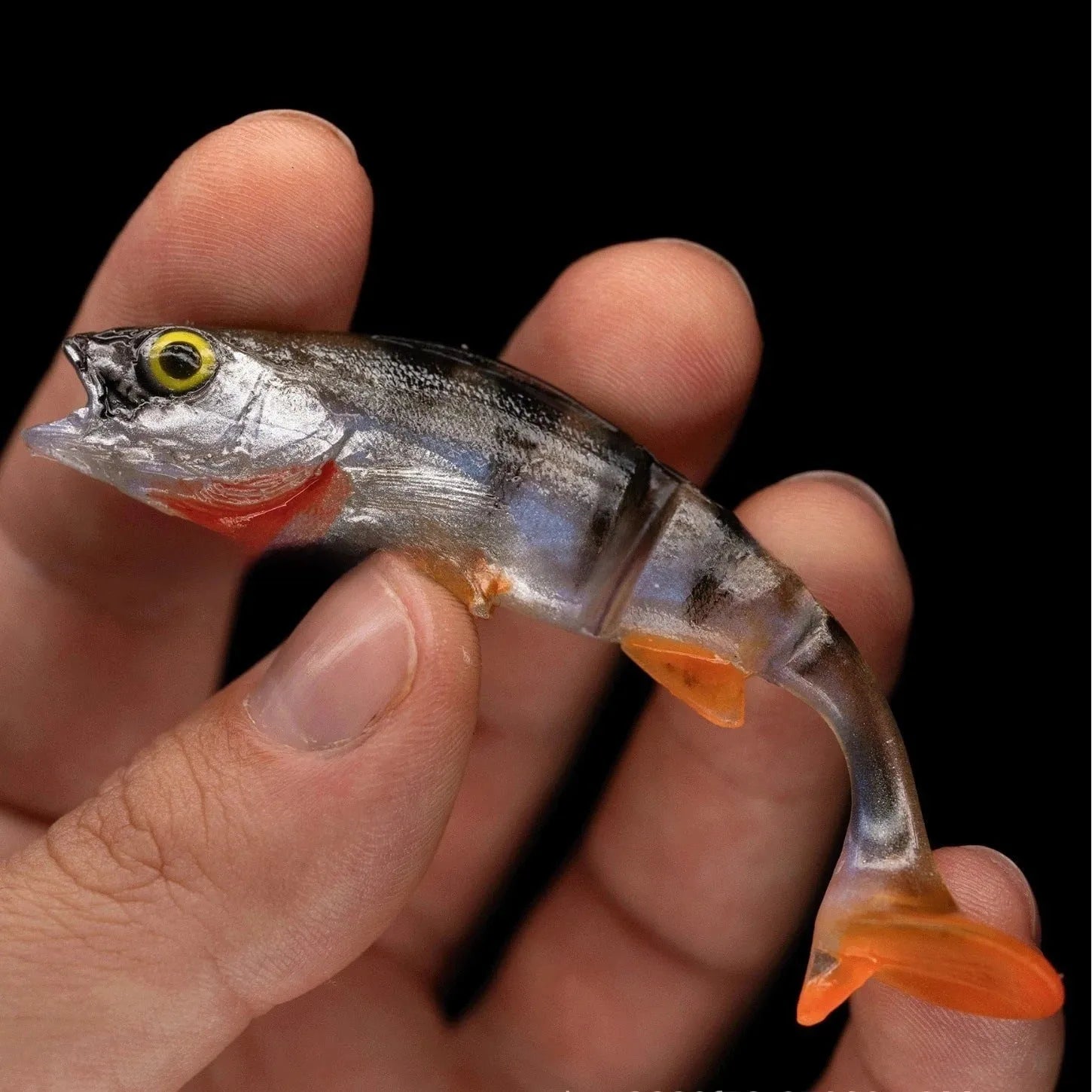 Soft plastic fishing lure in fish shape with T-tail and catfish scissors profile for sea fishing