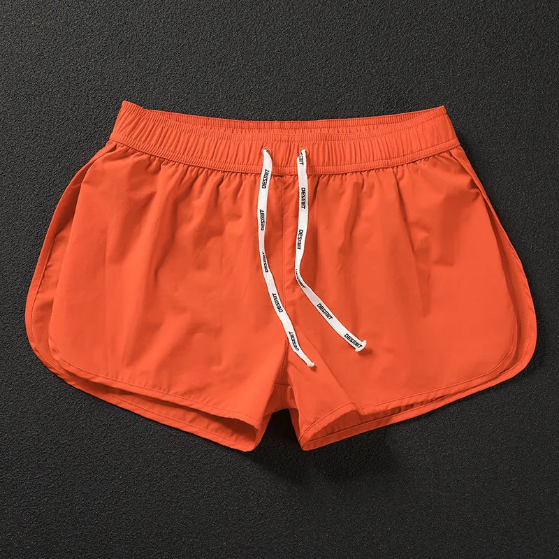 Men's loose orange, fluorescent green, or black polyester beach shorts on a size chart