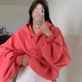 Watermelon red women's silk hooded sweater on hanger showing sleeveless design