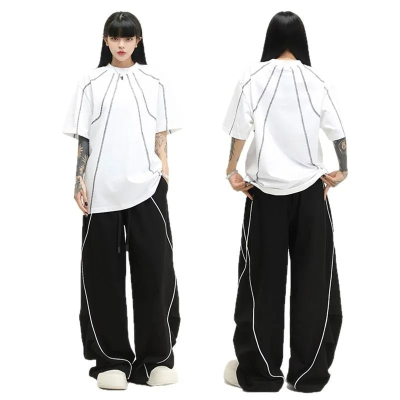 Black striped hip hop trousers with wide-leg pleated design showing mid-waist styling