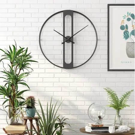 Round metal wall clock in black or gold, 50 cm diameter, on a white wall.