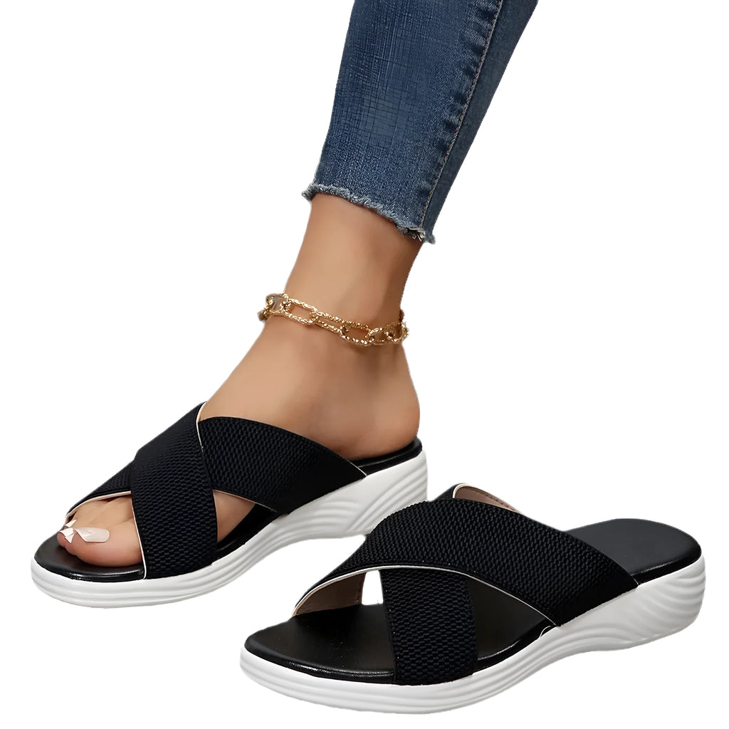 Black women's flat wedge peep-toe slippers with a thick rubber sole and PVC upper.