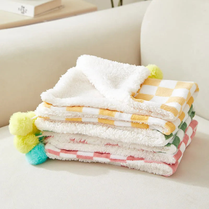 Plush fleece pet blanket with plaid pattern and fur ball decoration for cats and dogs