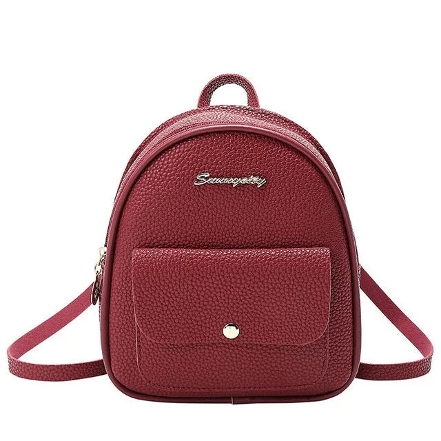 Small black PU women's backpack with zip closure shown as shoulder bag and backpack