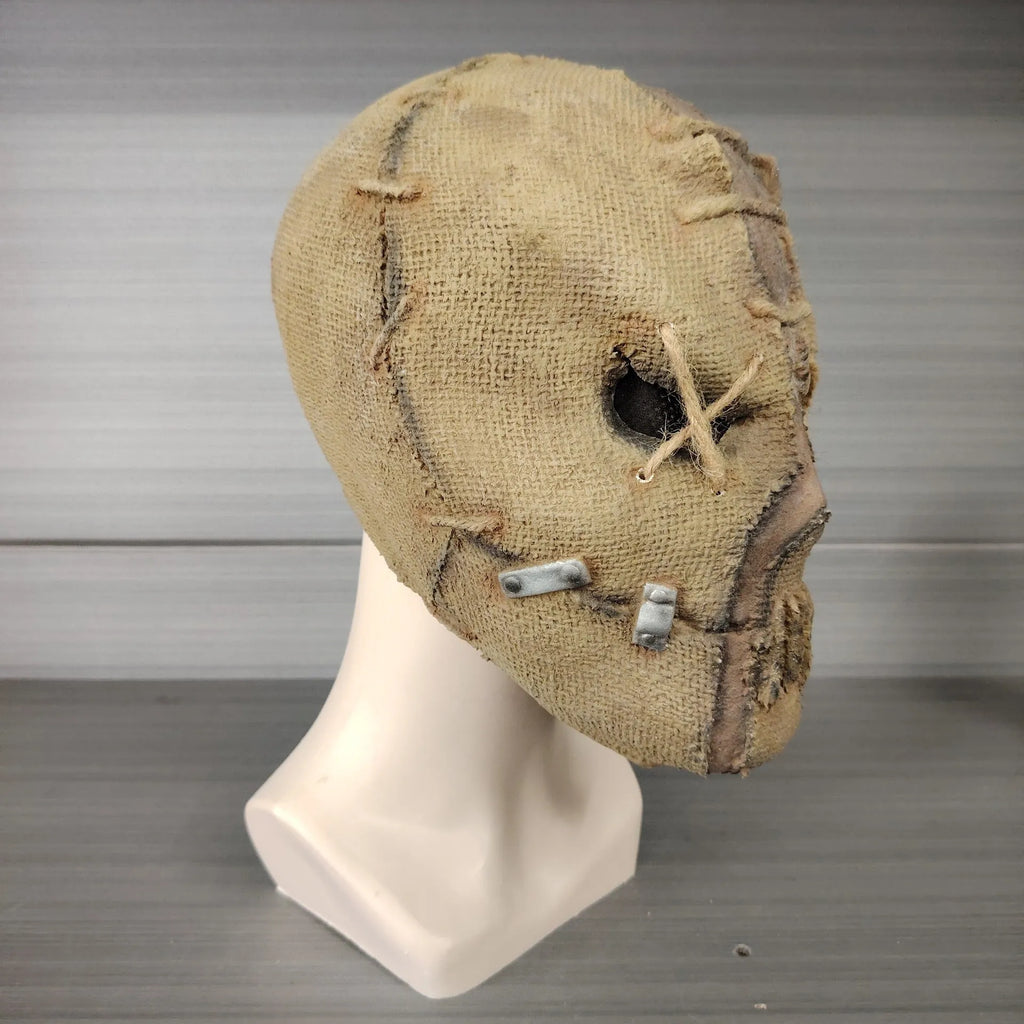 Latex horror mask with scar skull design worn as a full head cover for Halloween costumes