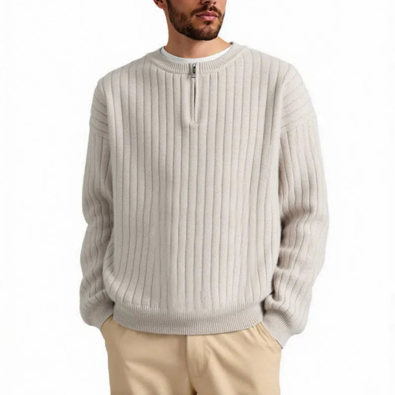 Men's grey half-zip loose knitted pullover sweater with textured fabric on a solid colour background.