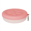 Portable plastic pet food bowl in light pink or green for outdoor travel feeding