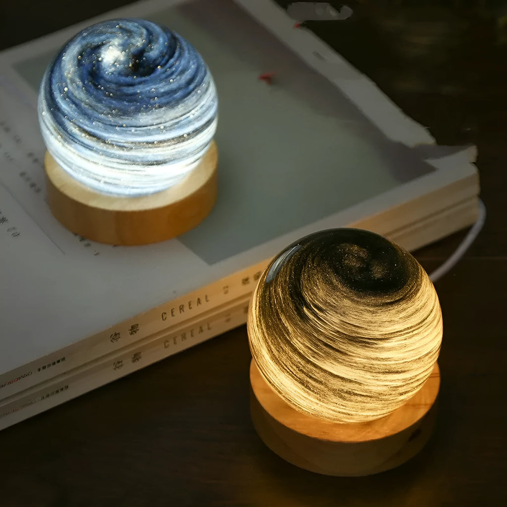 Spherical planet night light with USB cable, showing modern design and soft LED glow.