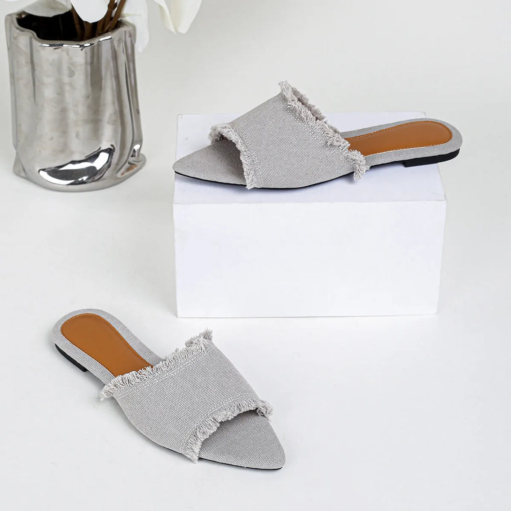 Women's denim flat slippers with tassel detail and leather lining in solid colour