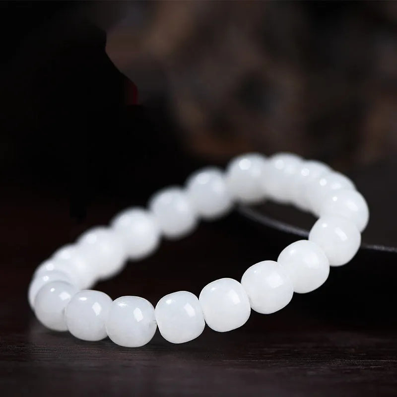White Hetian jade barrel bead bracelet showing three bead size options on wrist