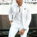 Men's white slim fit two-piece cotton suit on a hanger, showing jacket and trousers for formal events.