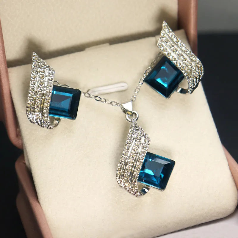 Women's necklace and earring set with glass pendant on cross chain necklace