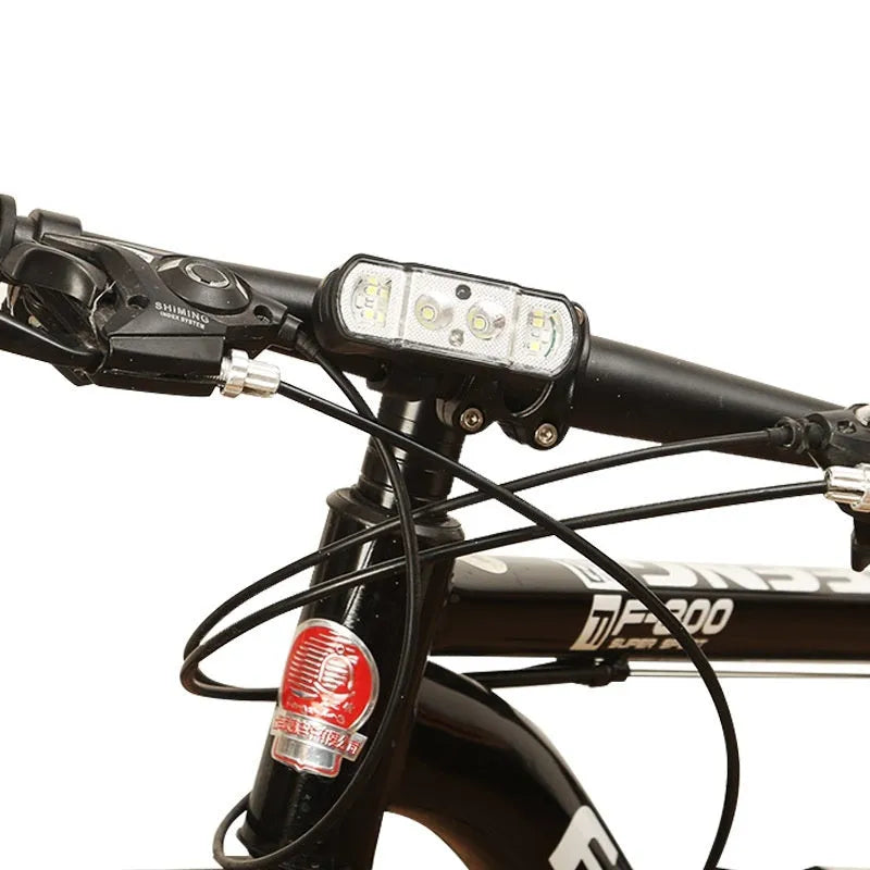 Black bicycle headlight with 350 lumen output and rechargeable battery mounted on handlebars