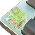 Green resin transparent keycap with glitter starry sky design for mechanical keyboards.