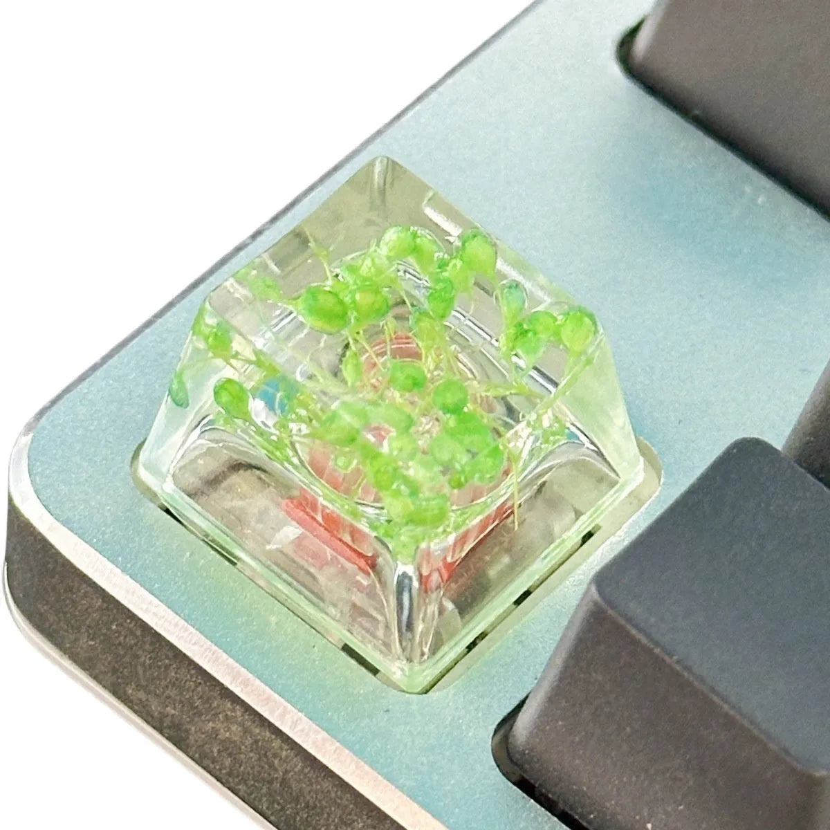 Green resin transparent keycap with glitter starry sky design for mechanical keyboards.