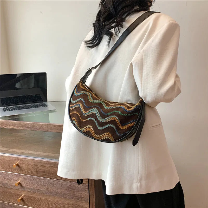Women's woven straw crossbody bag showing internal phone compartment and file pocket in milky white colour