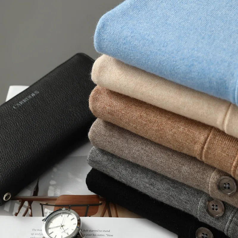 Man wearing a beige Andy velvet V-neck cardigan coat with long sleeves in a loose fit.