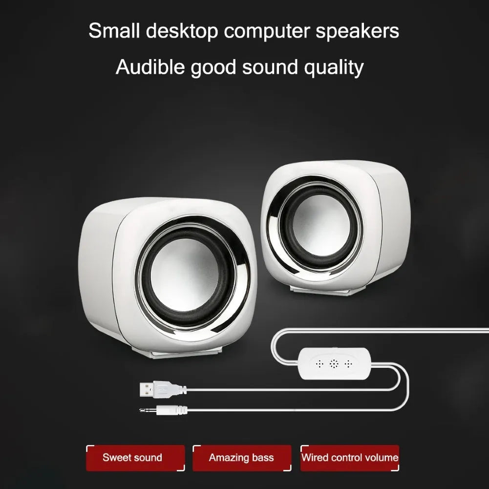 Pair of compact black wired computer speakers with 3.5mm plug showing 7.2cm cube dimensions