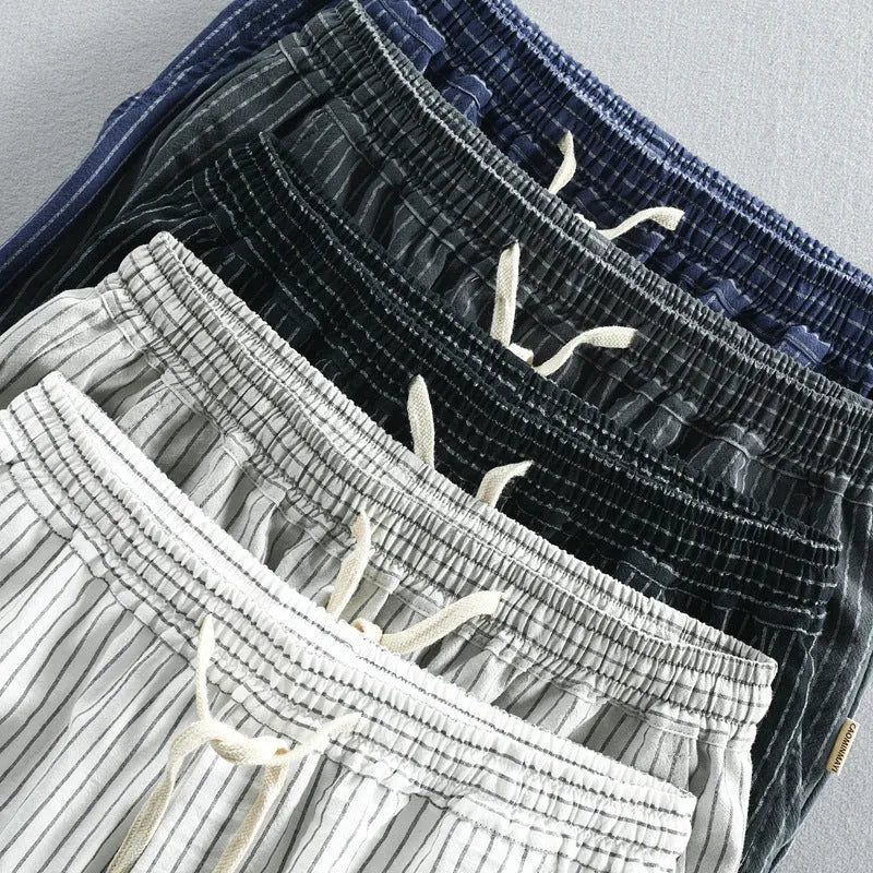 Man wearing loose fit striped cotton shorts in a casual setting.