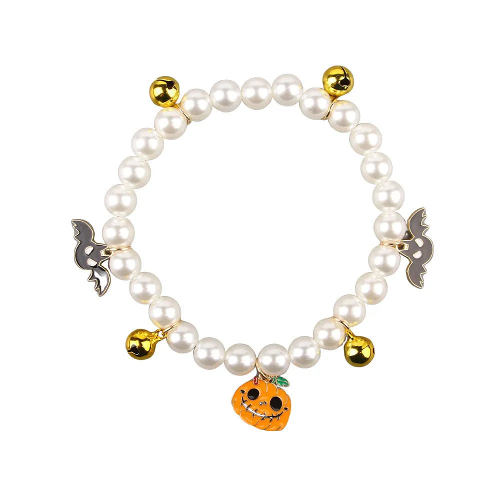 Halloween-themed cat collar with simulated pearl beading showing purple ghost pumpkin design.