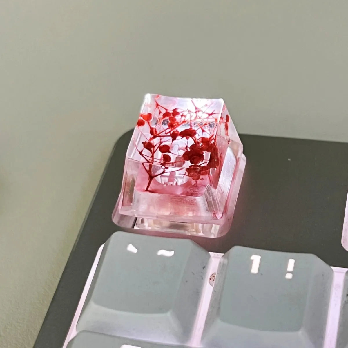 Green resin transparent keycap with glitter starry sky design for mechanical keyboards.