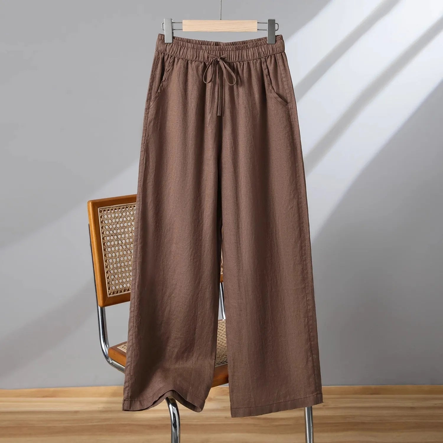 Women's straight-leg casual trousers in apricot colour with elastic waist and lace-up front detail.