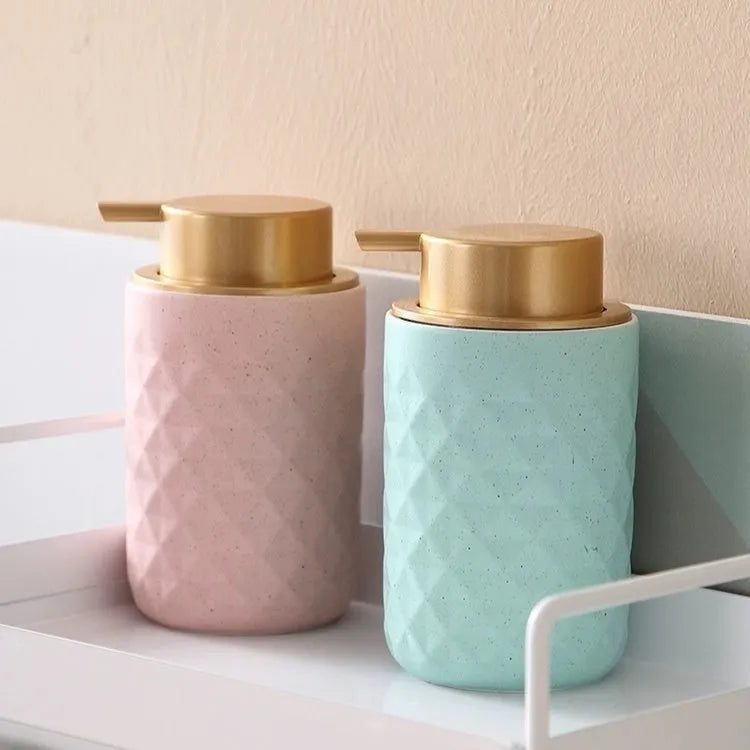 Foam pump bottle dispenser with large metallic pump head for facial cleanser.