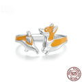 Silver-coloured cartoon corgi dog ring for women on a plain background.
