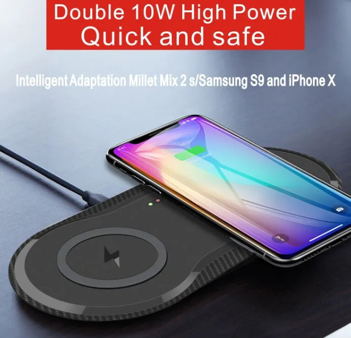 Black dual wireless charging pad charging two smartphones simultaneously on desk