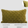 Brown gold antique quilted square cushion pillow on a sofa next to a green waist pillow.