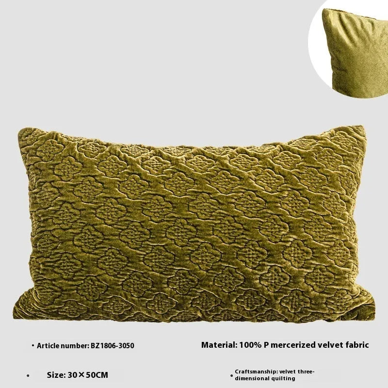 Brown gold antique quilted square cushion pillow on a sofa next to a green waist pillow.