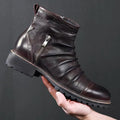 Black mid-calf cowboy boots with side zip, round toe, and embossed PU upper on a brown background.